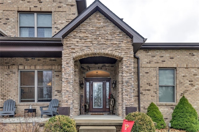 doorway to property with brick siding