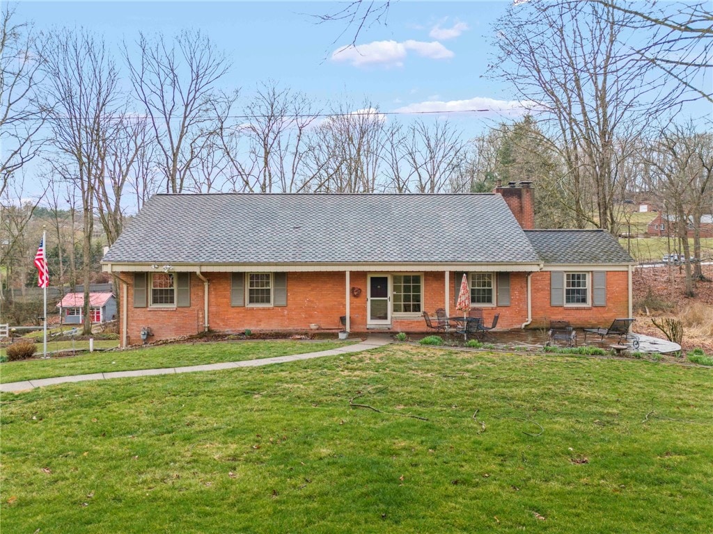 105 Fairway Dr, Peters Twp, PA 15317 - ranch-style house with a chimney, brick siding, and a front lawn