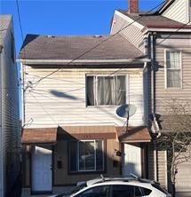 back of property with a chimney