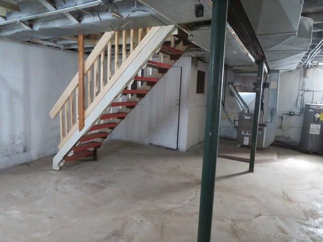 501 Adams St, West Newton, PA 15089 - unfinished below grade area with electric water heater, stairs, and heating unit