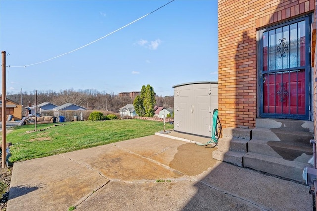 view of yard featuring an outbuilding, a storage shed, and entry steps
