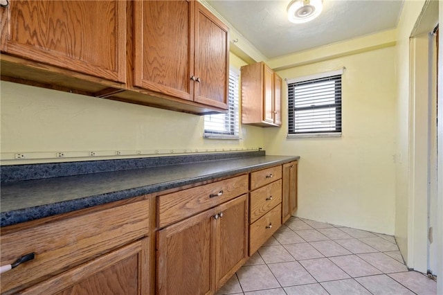 washroom featuring light tile patterned floors and crown molding