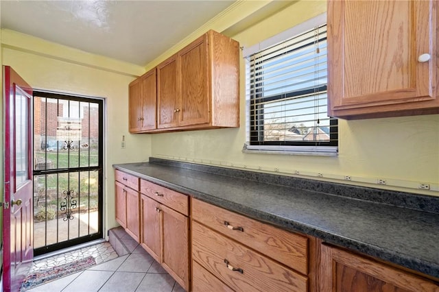 kitchen with dark countertops and light tile patterned flooring