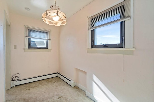 empty room featuring a notable chandelier, carpet, and baseboards