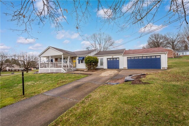 view of front facade with driveway, a garage, a porch, and a front yard