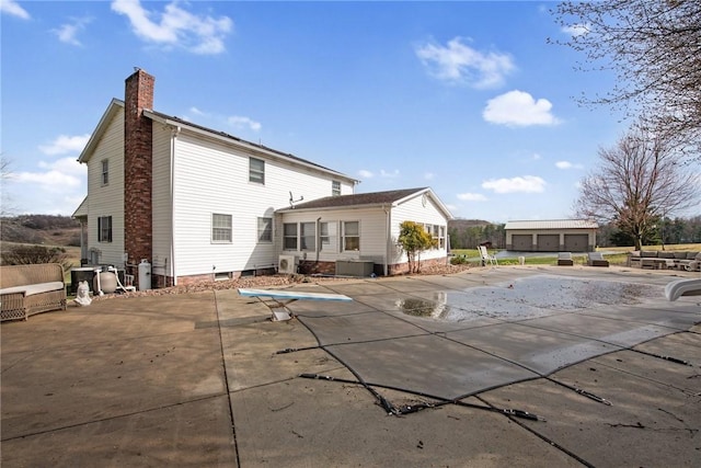 19 Misty Meadows Ln, Menallen Twp, PA 15401 - back of house with a chimney, a patio area, and a covered pool