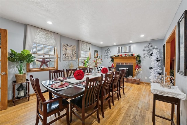 19 Misty Meadows Ln, Menallen Twp, PA 15401 - dining area featuring light wood-type flooring, a textured ceiling, recessed lighting, and a brick fireplace