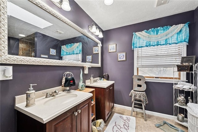 19 Misty Meadows Ln, Menallen Twp, PA 15401 - full bathroom with two vanities, tile patterned flooring, and a textured ceiling