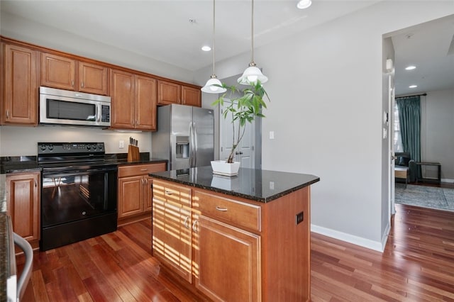 2802 Jane St, South Side, PA 15203 - kitchen featuring appliances with stainless steel finishes, dark wood-type flooring, pendant lighting, a center island, and recessed lighting