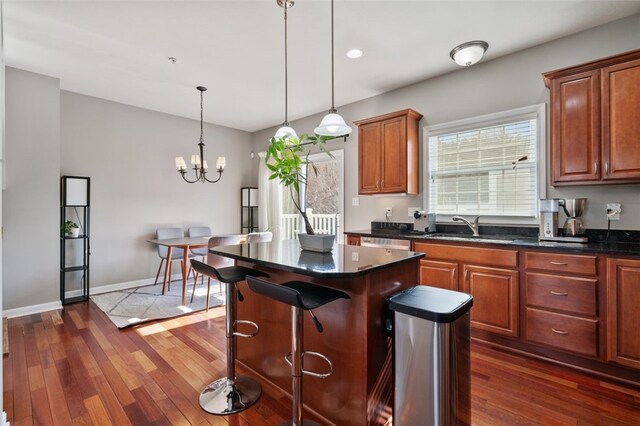 2802 Jane St, South Side, PA 15203 - kitchen with dark wood finished floors, a kitchen island, a sink, and a chandelier