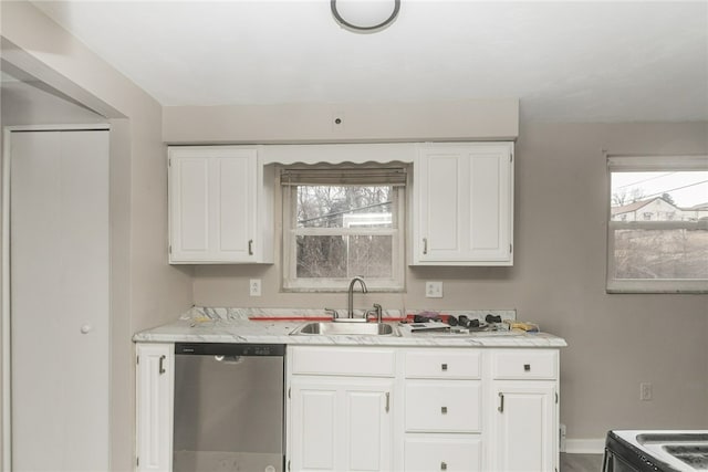 kitchen with a sink, white cabinetry, baseboards, and dishwasher