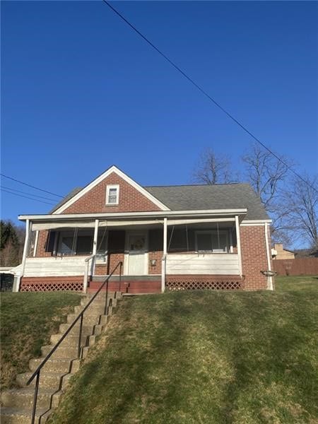 1203 Vine St, West Newton, PA 15089 - view of front of house featuring brick siding and a front lawn