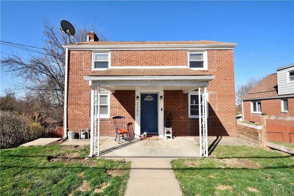 2252 Candace St, Beechview, PA 15216 - view of front facade with brick siding, a porch, a front lawn, and a chimney