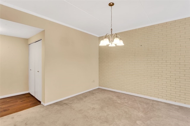 5841 Morrowfield Ave Unit 104, Squirrel Hill, PA 15217 - spare room featuring carpet, brick wall, a chandelier, and crown molding