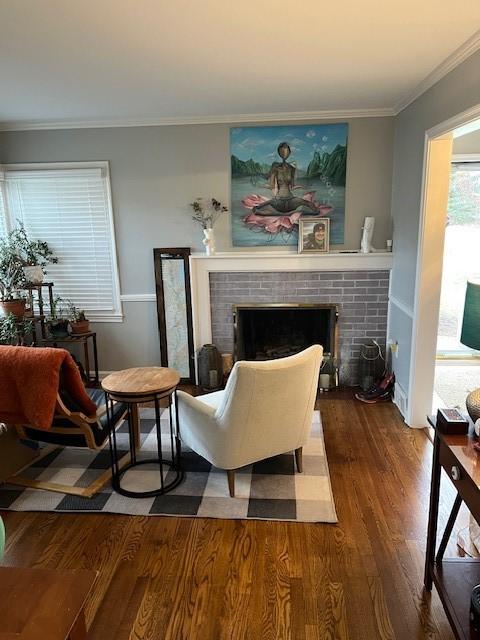 111 Mckenney Dr, Brighton Twp, PA 15009 - living area featuring ornamental molding, a brick fireplace, and wood finished floors