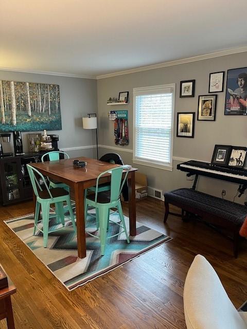 111 Mckenney Dr, Brighton Twp, PA 15009 - dining room featuring crown molding, baseboards, visible vents, and wood finished floors
