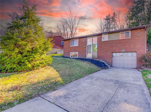 130 Castle, West Mifflin, PA 15122 - bi-level home with brick siding, driveway, a garage, and a lawn