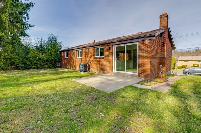 130 Castle, West Mifflin, PA 15122 - rear view of house with central air condition unit, a chimney, brick siding, a yard, and a patio area