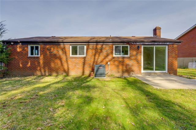 130 Castle, West Mifflin, PA 15122 - back of property with brick siding, central air condition unit, a yard, and a patio area