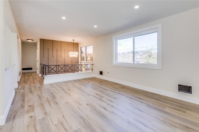130 Castle, West Mifflin, PA 15122 - unfurnished living room featuring baseboards, visible vents, light wood-style floors, recessed lighting, and an inviting chandelier