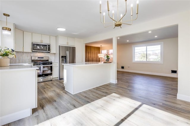 130 Castle, West Mifflin, PA 15122 - kitchen featuring light countertops, a chandelier, backsplash, and stainless steel appliances