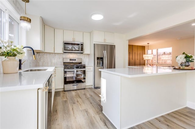 130 Castle, West Mifflin, PA 15122 - kitchen with a sink, light countertops, decorative backsplash, and appliances with stainless steel finishes