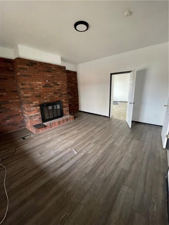 401 Allen, Allentown, PA 15210 - unfurnished living room featuring wood finished floors and a brick fireplace