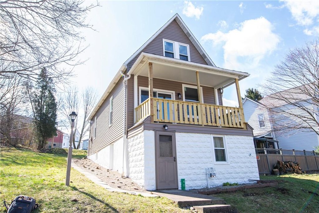 back of property with a yard