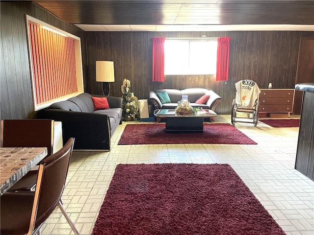 living area featuring wooden walls and brick patterned floor