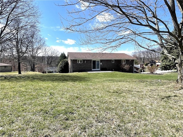 back of house featuring a yard and a patio area