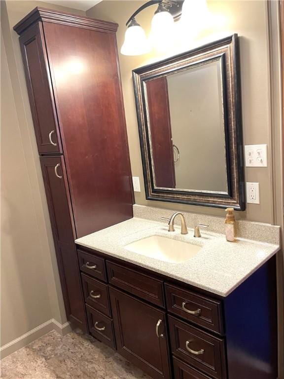 bathroom with vanity and baseboards
