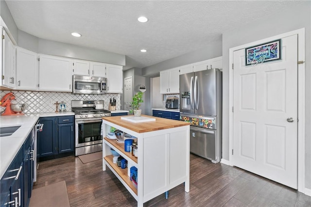 145 Brighton Ln, Adams Twp, PA 16046 - kitchen with appliances with stainless steel finishes, wood counters, blue cabinetry, dark wood finished floors, and white cabinetry