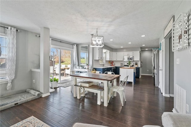 145 Brighton Ln, Adams Twp, PA 16046 - dining area featuring dark wood-style flooring, a textured ceiling, a chandelier, baseboards, and recessed lighting