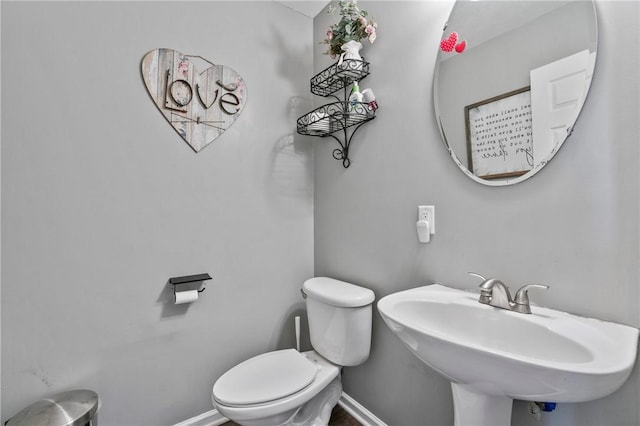 145 Brighton Ln, Adams Twp, PA 16046 - half bathroom featuring toilet, a sink, and baseboards
