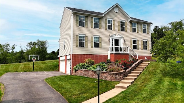 145 Brighton Ln, Adams Twp, PA 16046 - colonial home with asphalt driveway, a front lawn, and a garage