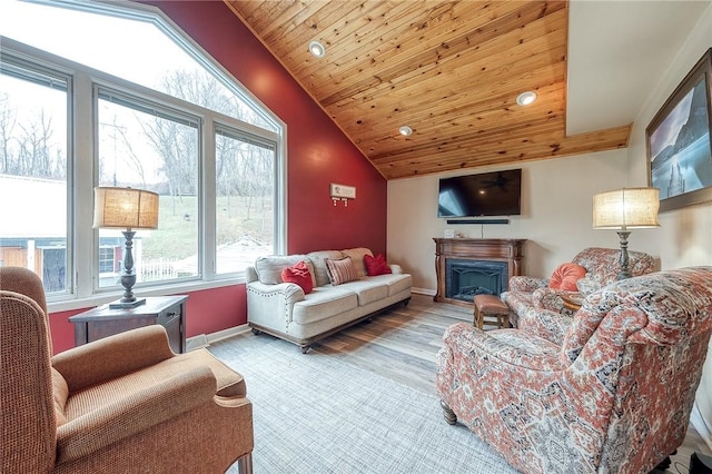 living room featuring vaulted ceiling, plenty of natural light, baseboards, wooden ceiling, and a fireplace