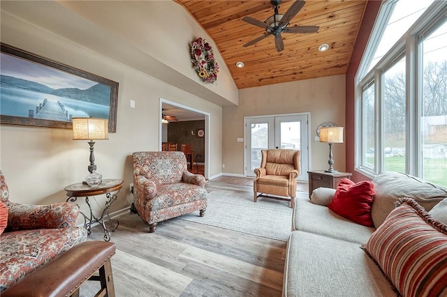 living room featuring wooden ceiling, ceiling fan, baseboards, wood finished floors, and high vaulted ceiling