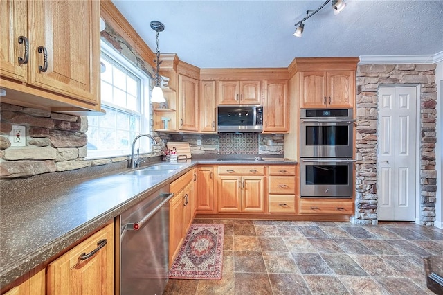 kitchen with stainless steel appliances, a sink, tasteful backsplash, dark countertops, and hanging light fixtures