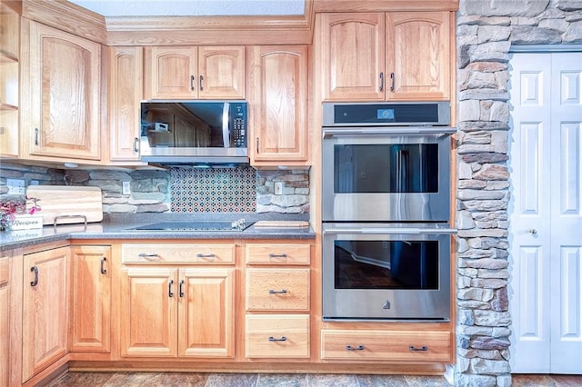 kitchen with appliances with stainless steel finishes, light brown cabinetry, and decorative backsplash
