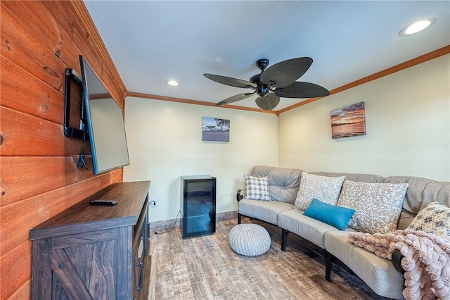 living room featuring ornamental molding, recessed lighting, wood finished floors, ceiling fan, and baseboards