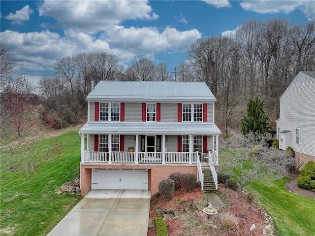 view of front facade featuring a porch, driveway, a front yard, metal roof, and stairway