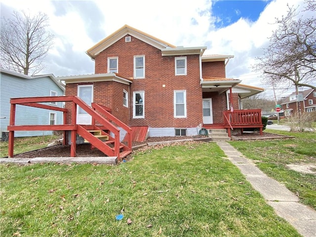 rear view of house with a lawn and brick siding