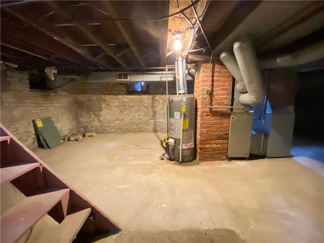 unfinished below grade area featuring visible vents and gas water heater