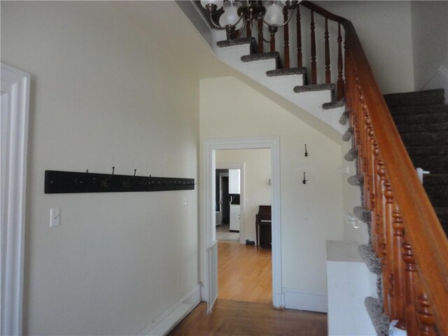 161 Ord St, Salisbury, PA 15558 - stairs featuring baseboards, wood finished floors, and a notable chandelier