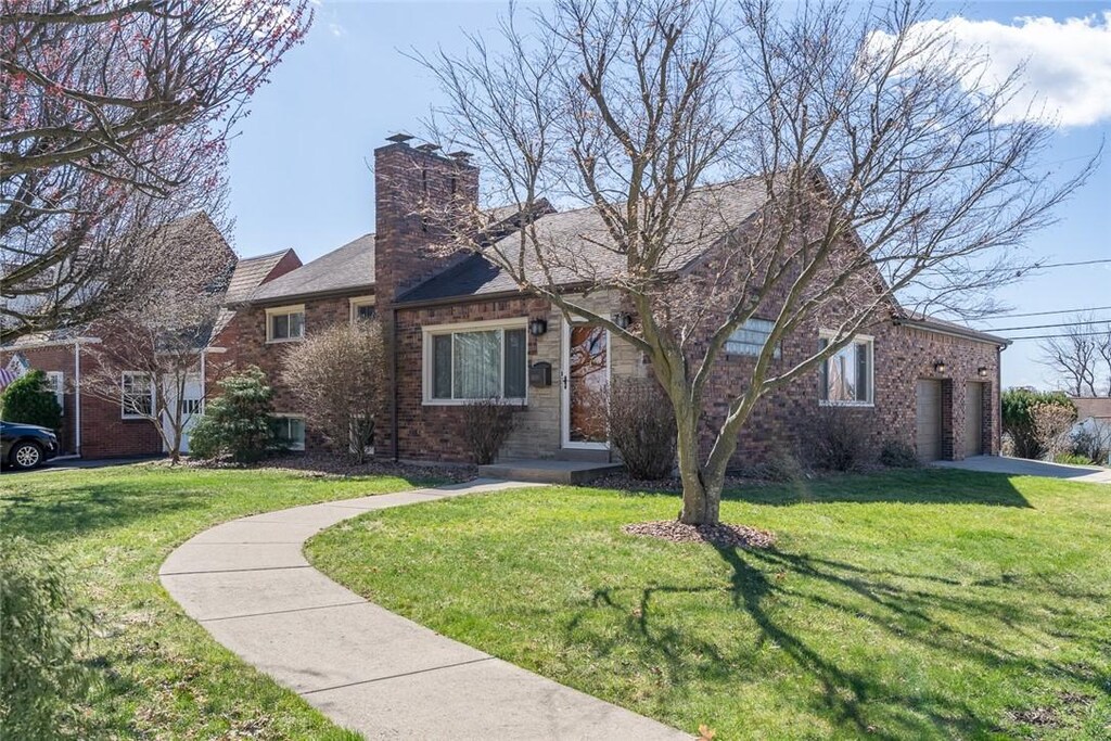 4800 Mooreridge, Whitehall, PA 15227 - view of front of house featuring brick siding, a chimney, concrete driveway, and a front yard