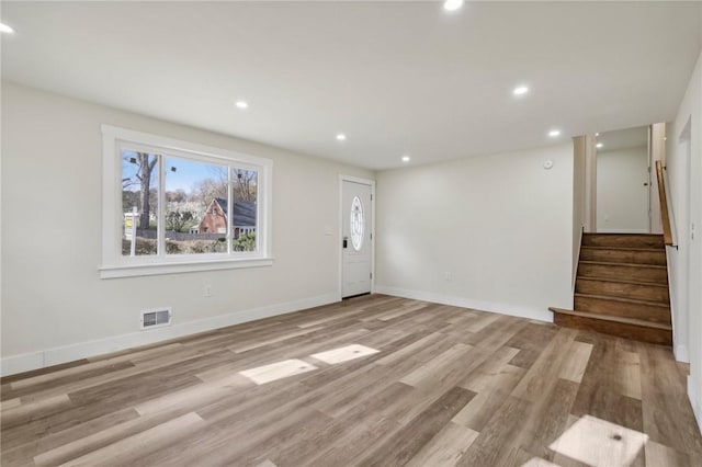 interior space with stairway, recessed lighting, baseboards, light wood-style floors, and visible vents