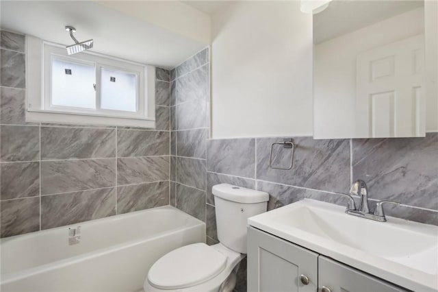 bathroom featuring tile walls, toilet, and vanity