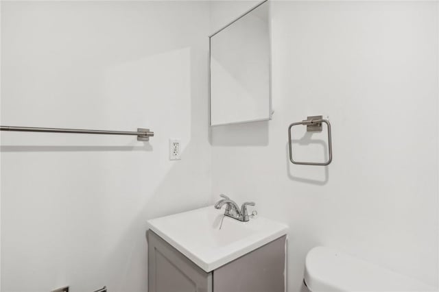 half bath featuring toilet and vanity