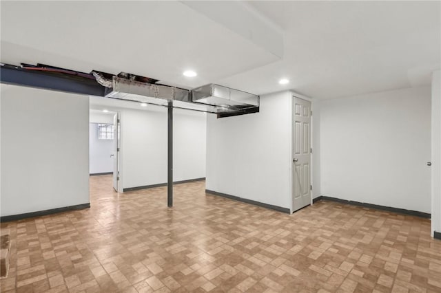 below grade area with baseboards and recessed lighting