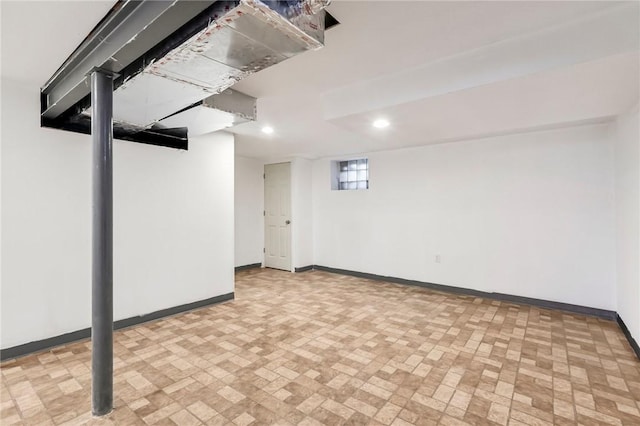 below grade area with baseboards and recessed lighting